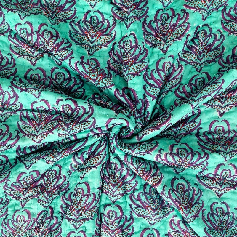 Pink Lotus reversible quilt from Bombaybirds with textured cotton fabric, showing intricate lotus pattern and soft pink color.