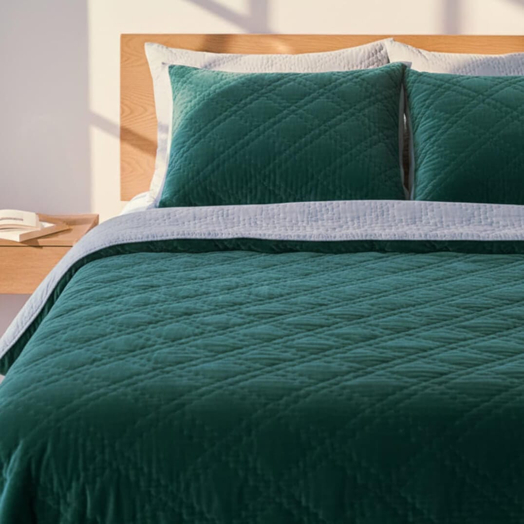 Emerald celeste velvet reversible quilt from Bombaybirds, showcasing luxurious green velvet upholstery for living room decor.