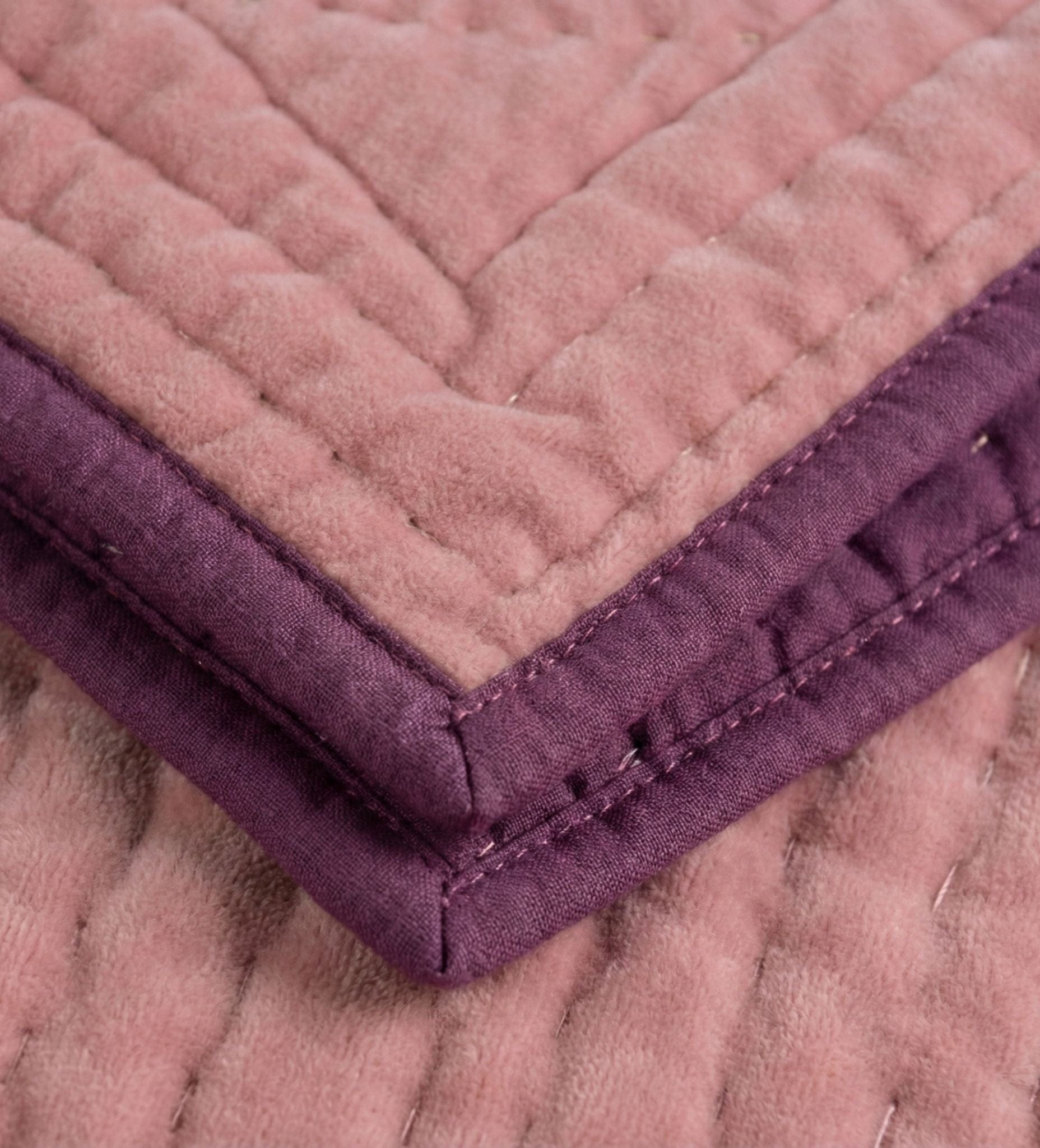 Pink velvet reversible quilt with berry and pink tones, detailed edge stitching, made by Bombaybirds for living room decor.