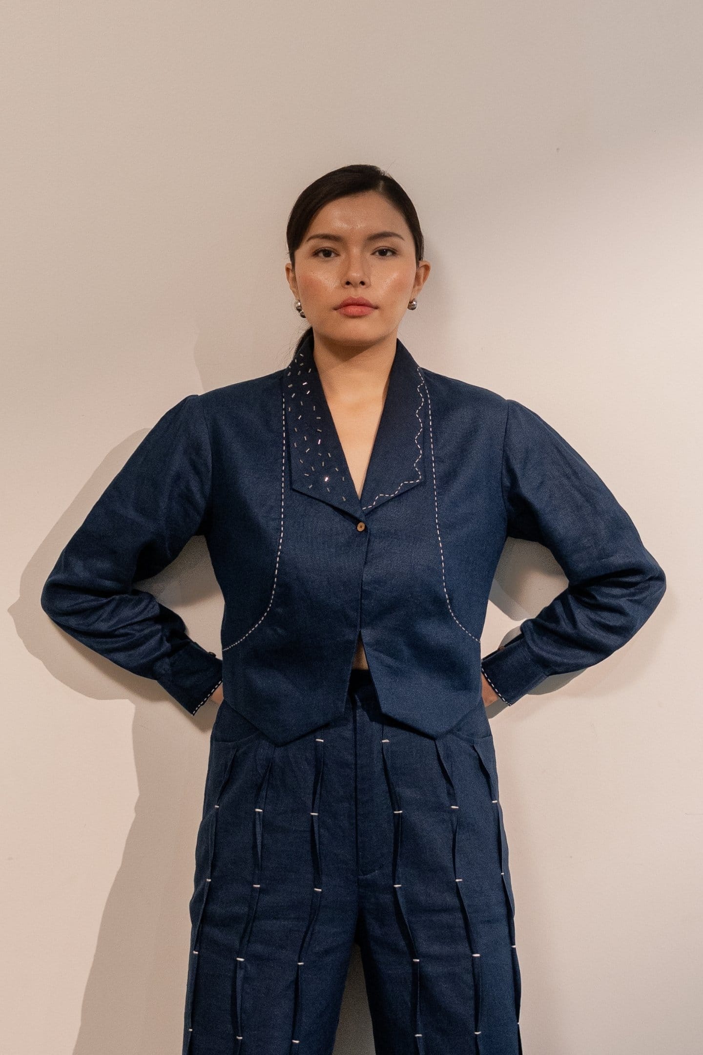 Navy blue Moraine crop blazer by Alternative, tailored with a fitted design and classic lapel collar, displayed on a mannequin.