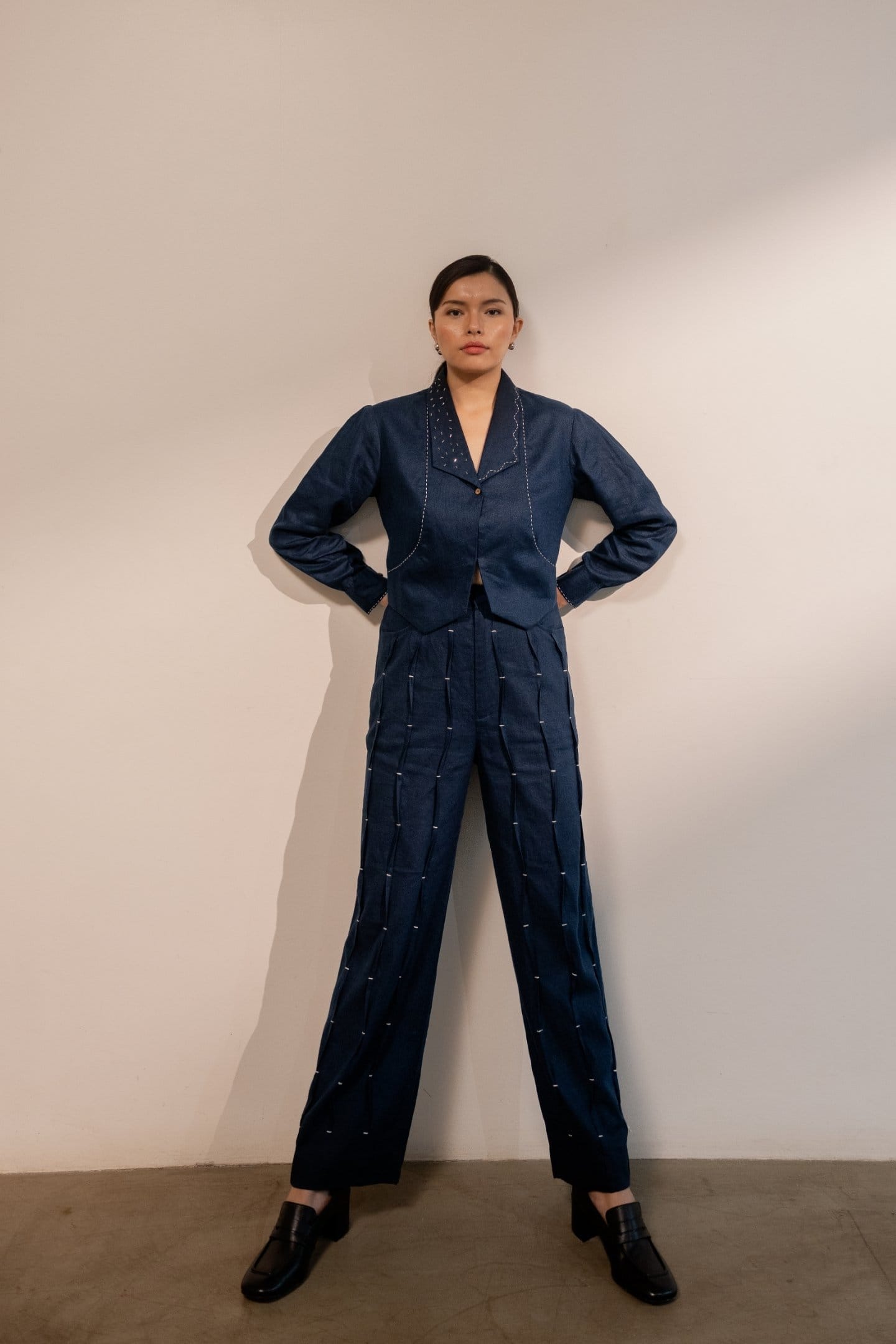 Navy blue Moraine crop blazer by Alternative, styled with matching pants, showcasing tailored fit and lightweight fabric.