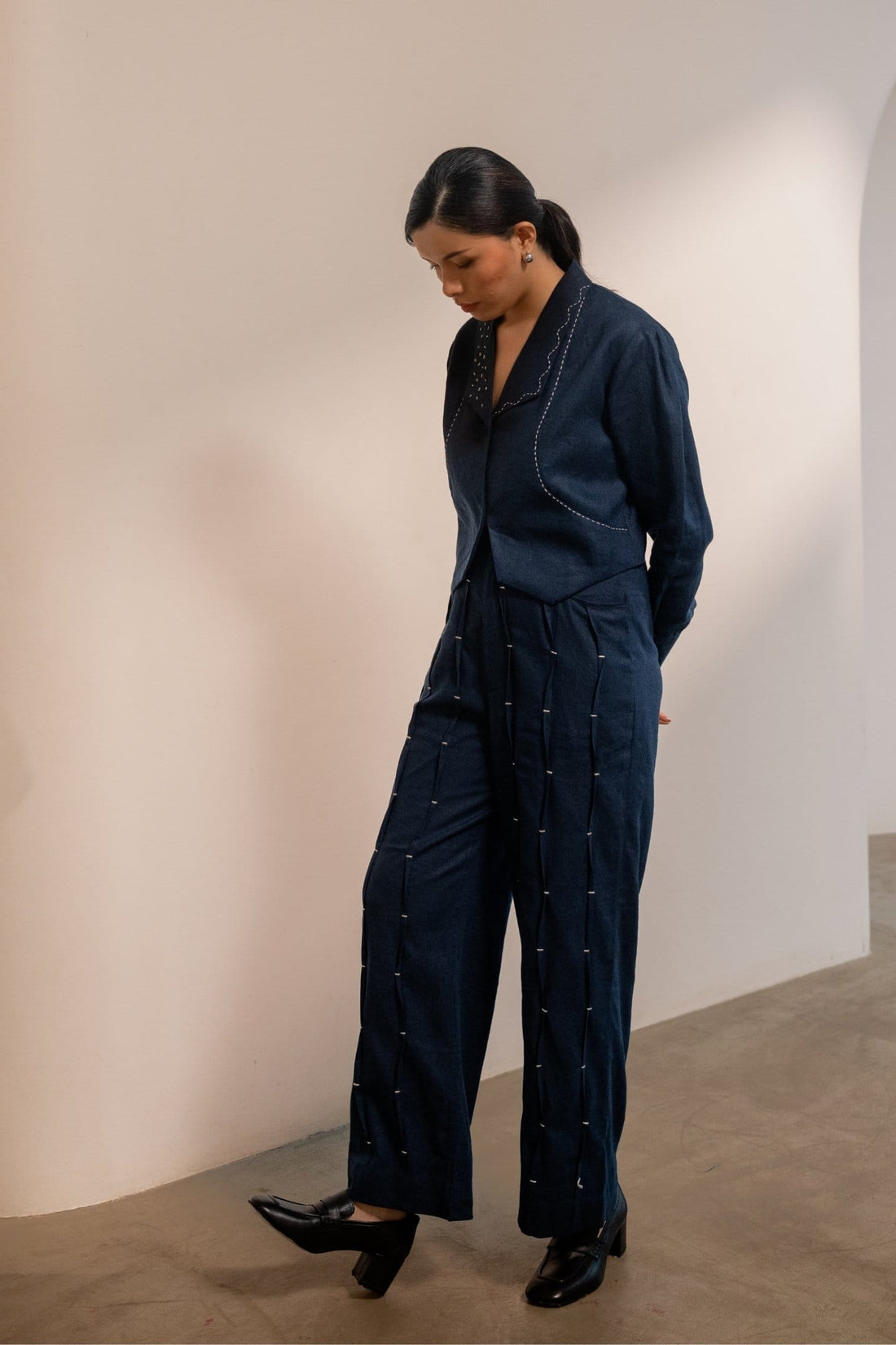 Navy blue Moraine crop blazer by Alternative, styled with matching pants, showcasing tailored fit and lightweight fabric.