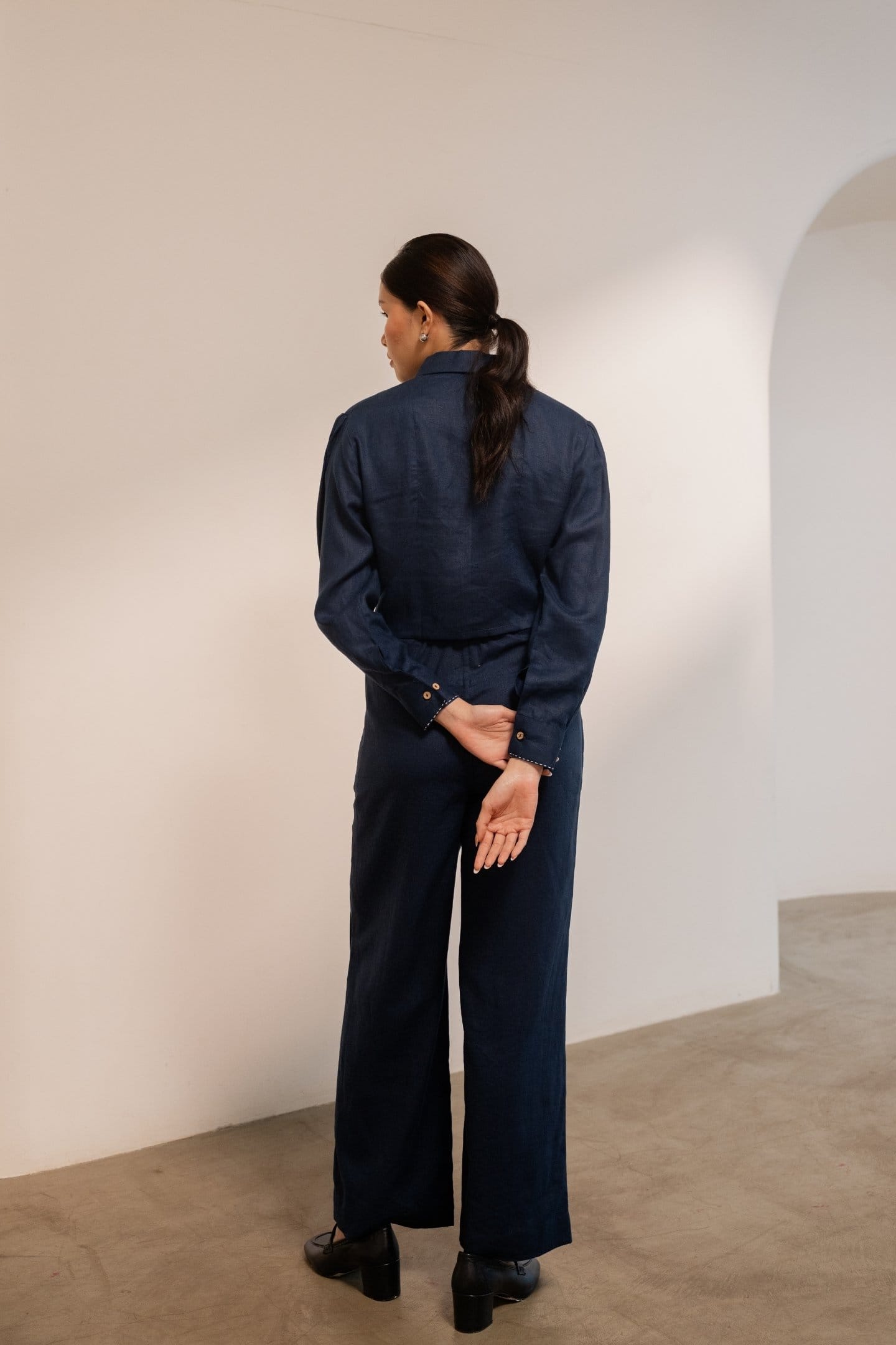 Navy blue Moraine crop blazer by Alternative, featuring a tailored fit and stylish design, shown on a model.