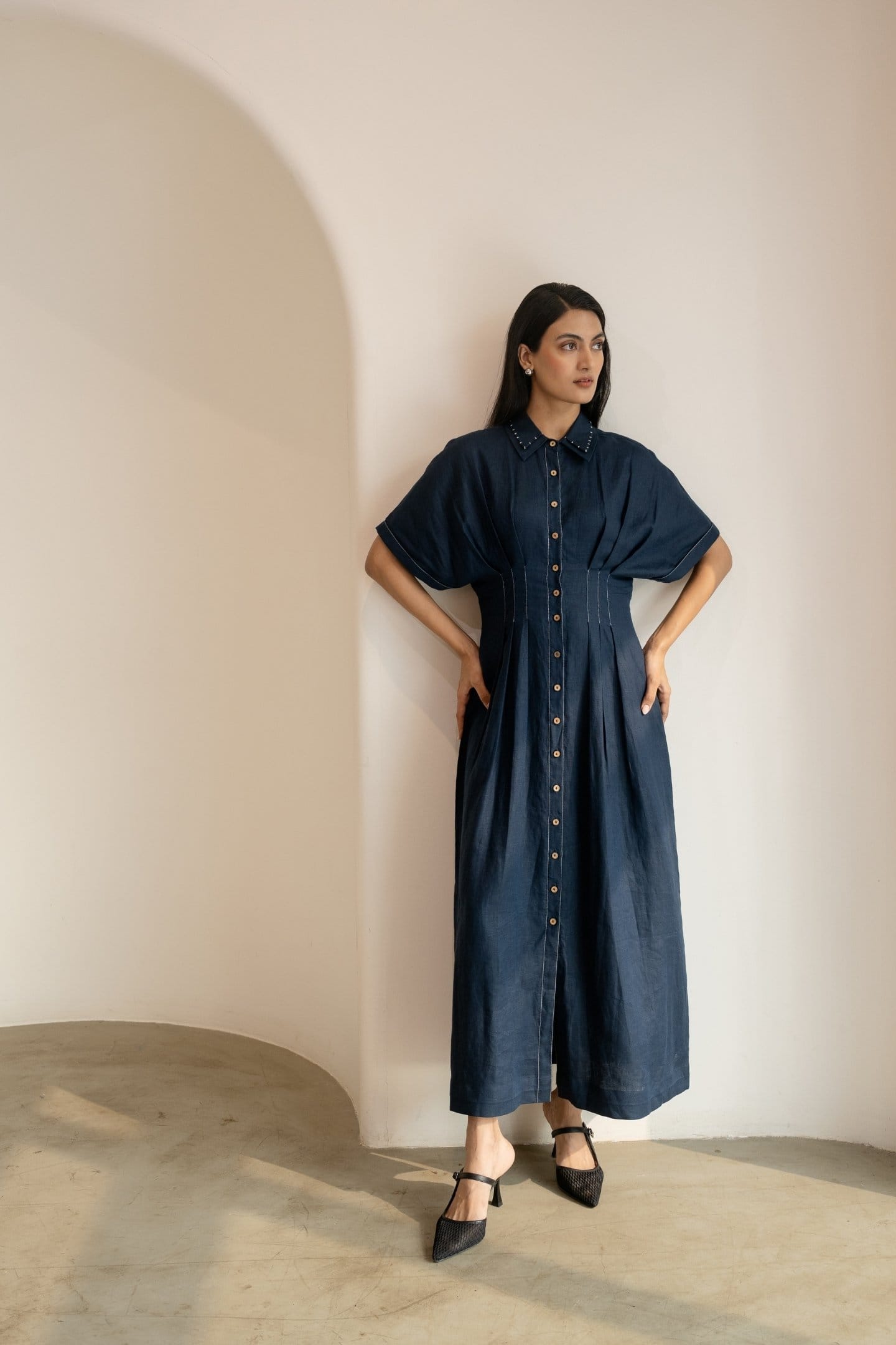 Navy blue Moraine maxi dress by Alternative featuring a flowing silhouette and elegant design, displayed on a hanger.