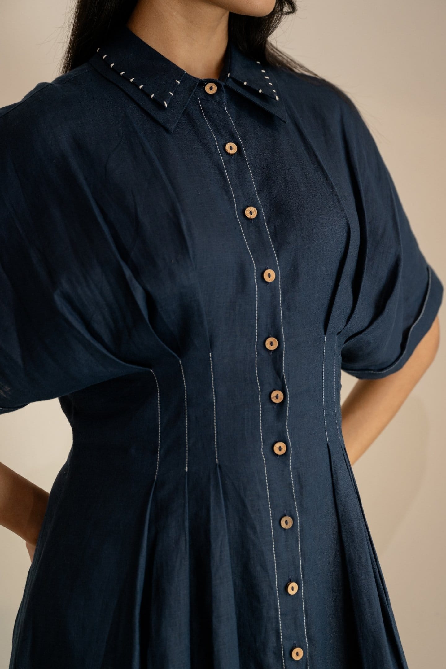 Navy blue Moraine maxi dress by Alternative, flowing fabric, sleeveless design, and elegant silhouette shown in the image.