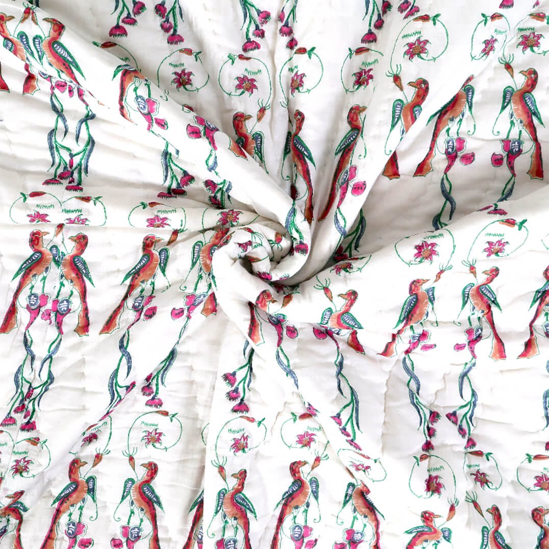 Close-up of Bombaybirds Ornitho reversible blanket showing soft cotton texture and detailed bird pattern.