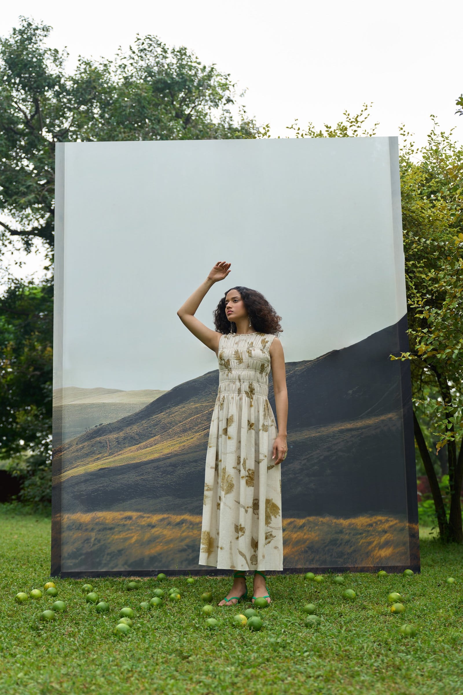 Alternative live leafy bell dress, short dress with vibrant leafy pattern, displayed on a hanger against a plain background.