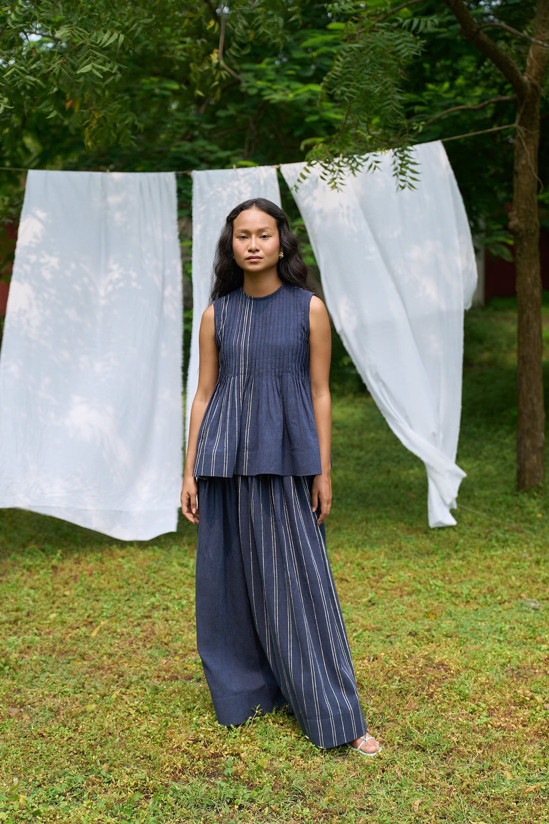 Cobalt sleeveless pintucks top by Alternative, showing front view with detailed pintuck design and sleeveless style.