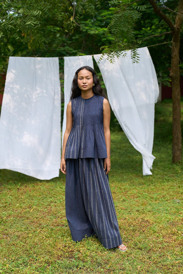 Cobalt pintucks skirt by Alternative, showcasing a stylish knee-length skirt with pintuck details and a flowy silhouette.