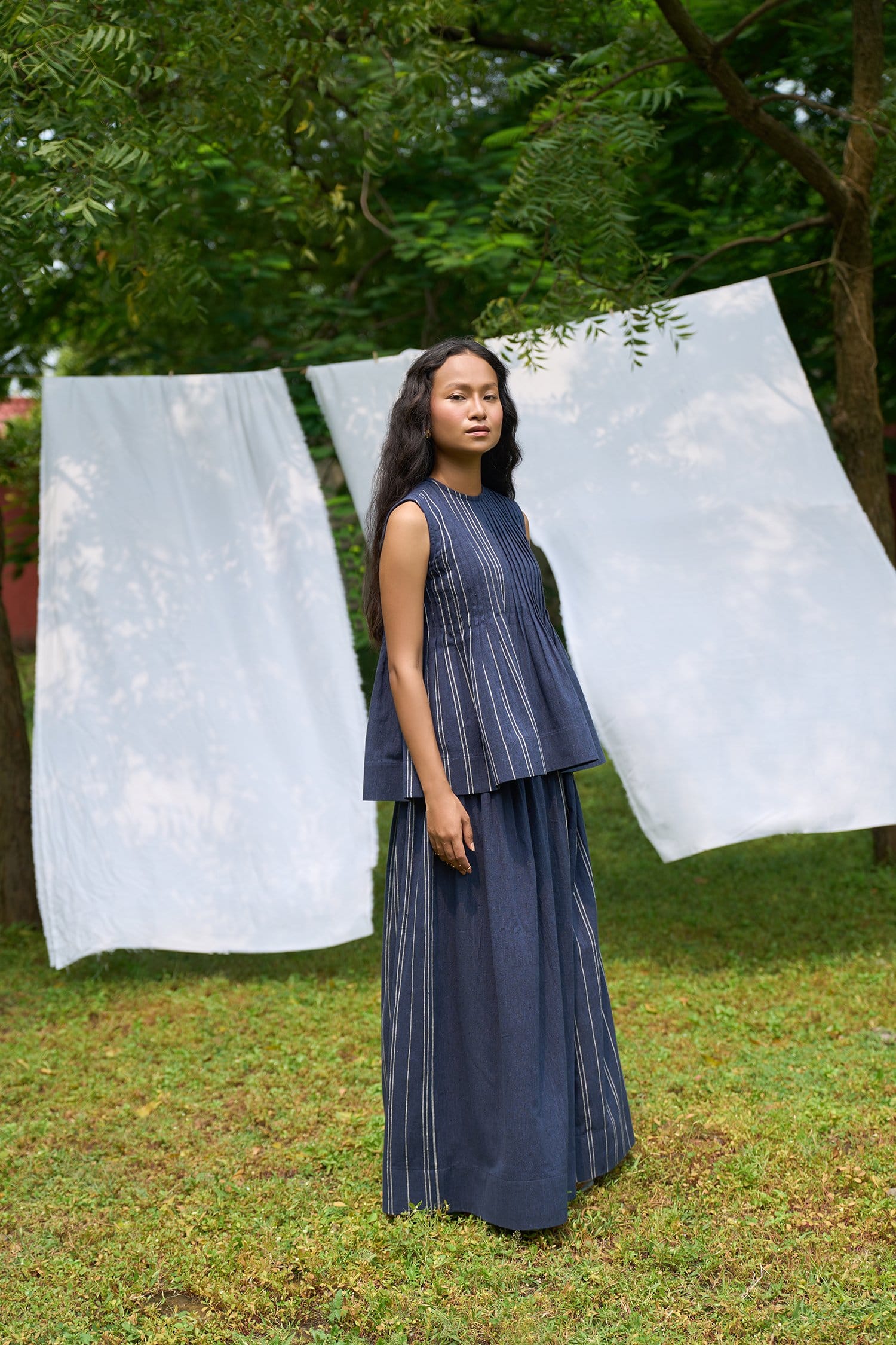 Cobalt sleeveless pintucks top by Alternative, featuring vertical pintuck details and a fitted sleeveless design.