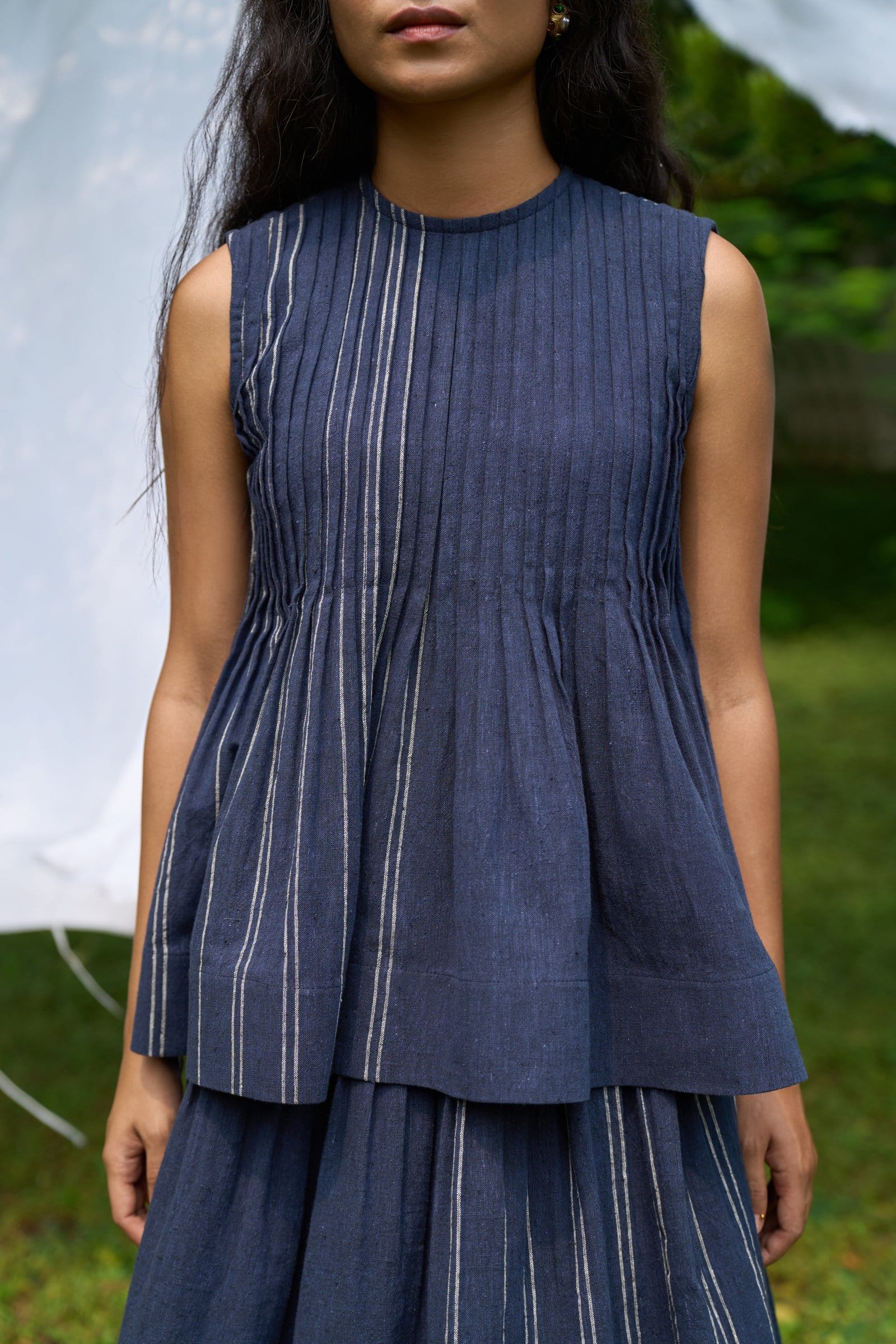 Cobalt sleeveless pintucks top by Alternative, featuring a stylish sleeveless design with pintuck details, perfect for casual wear.