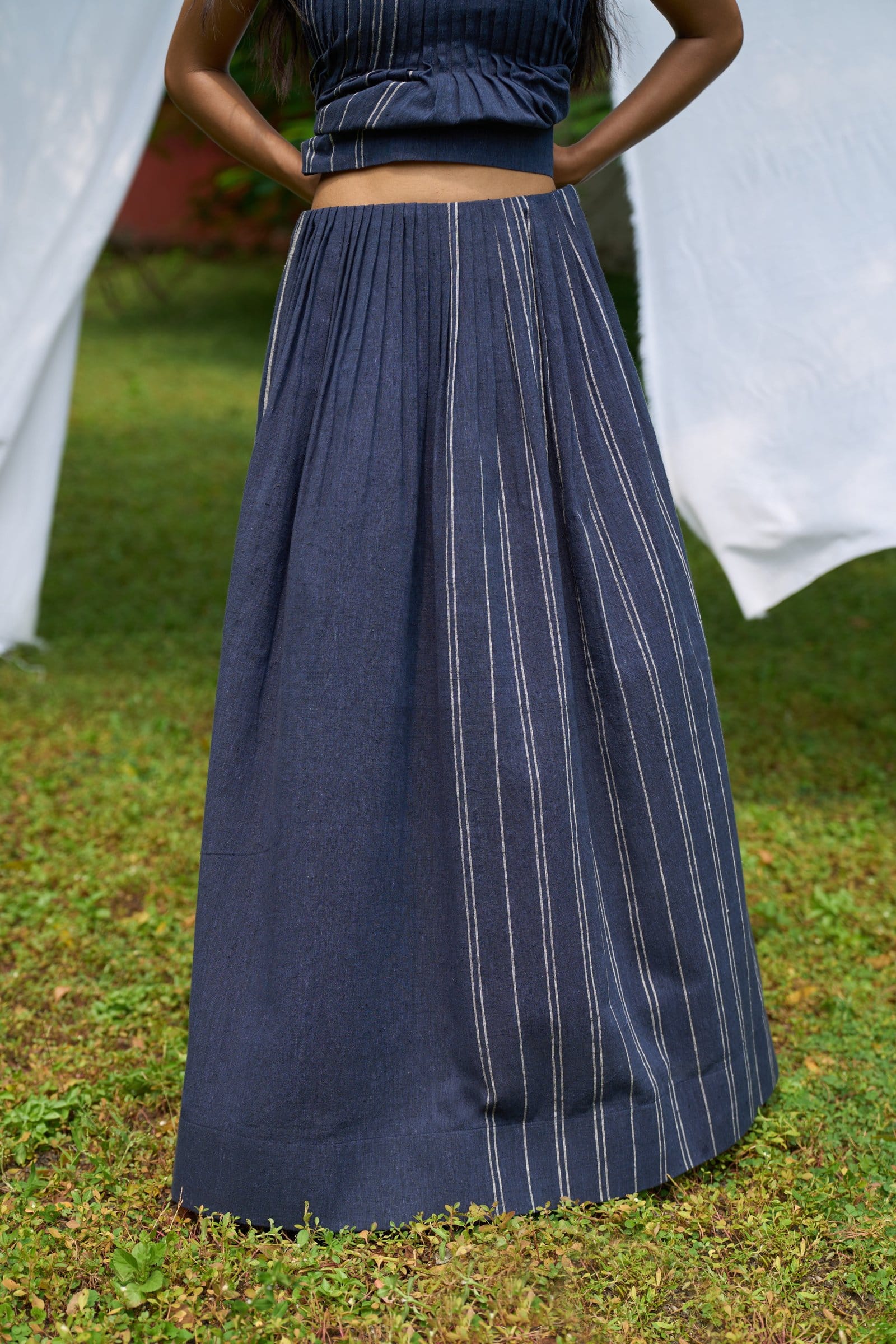 Cobalt pintucks skirt by Alternative, showing a close-up of the pleated design and fabric texture.