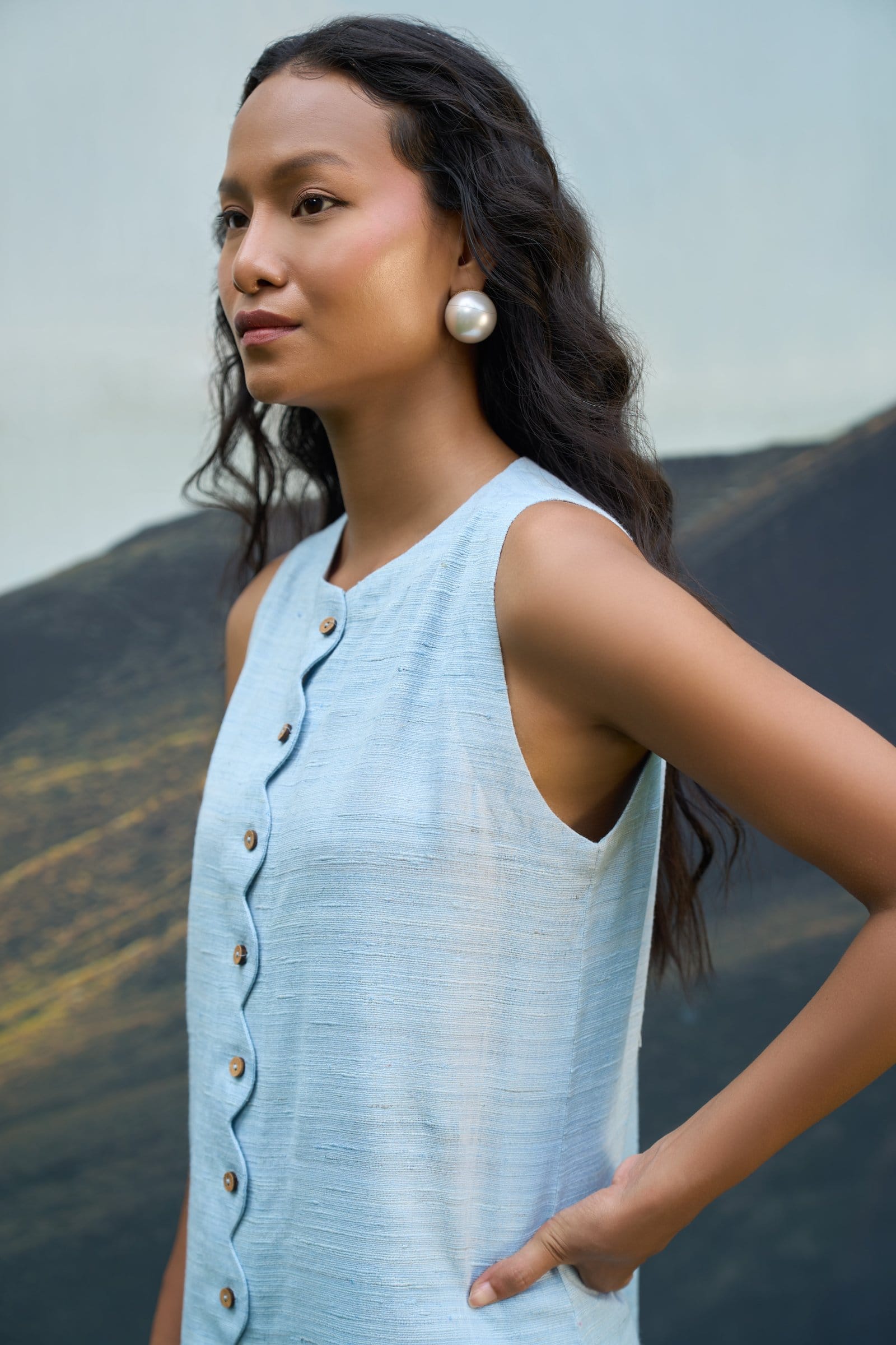 Alternative Petal sleeveless short dress displayed on a model, featuring a flowy design and vibrant floral pattern.