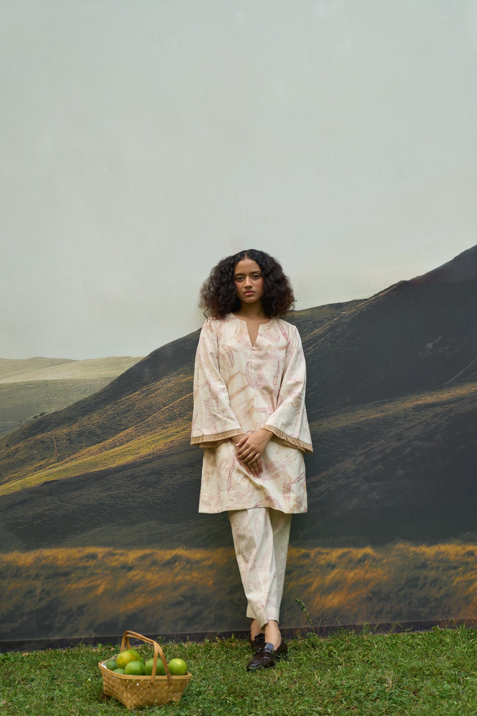 Pink foliage flared trousers from Alternative, showcasing vibrant floral print and wide-leg design on a white background.