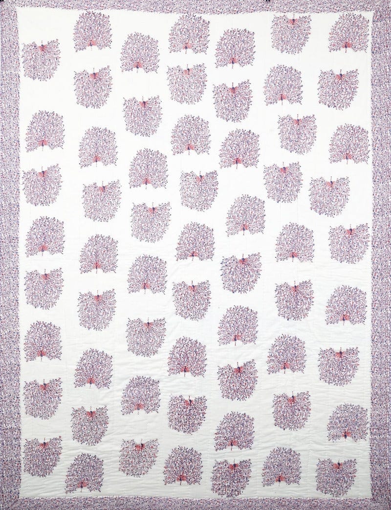 Reversible quilt featuring peacock feathers pattern from Bombaybirds, showcasing intricate Indian handwork design in vibrant colors.