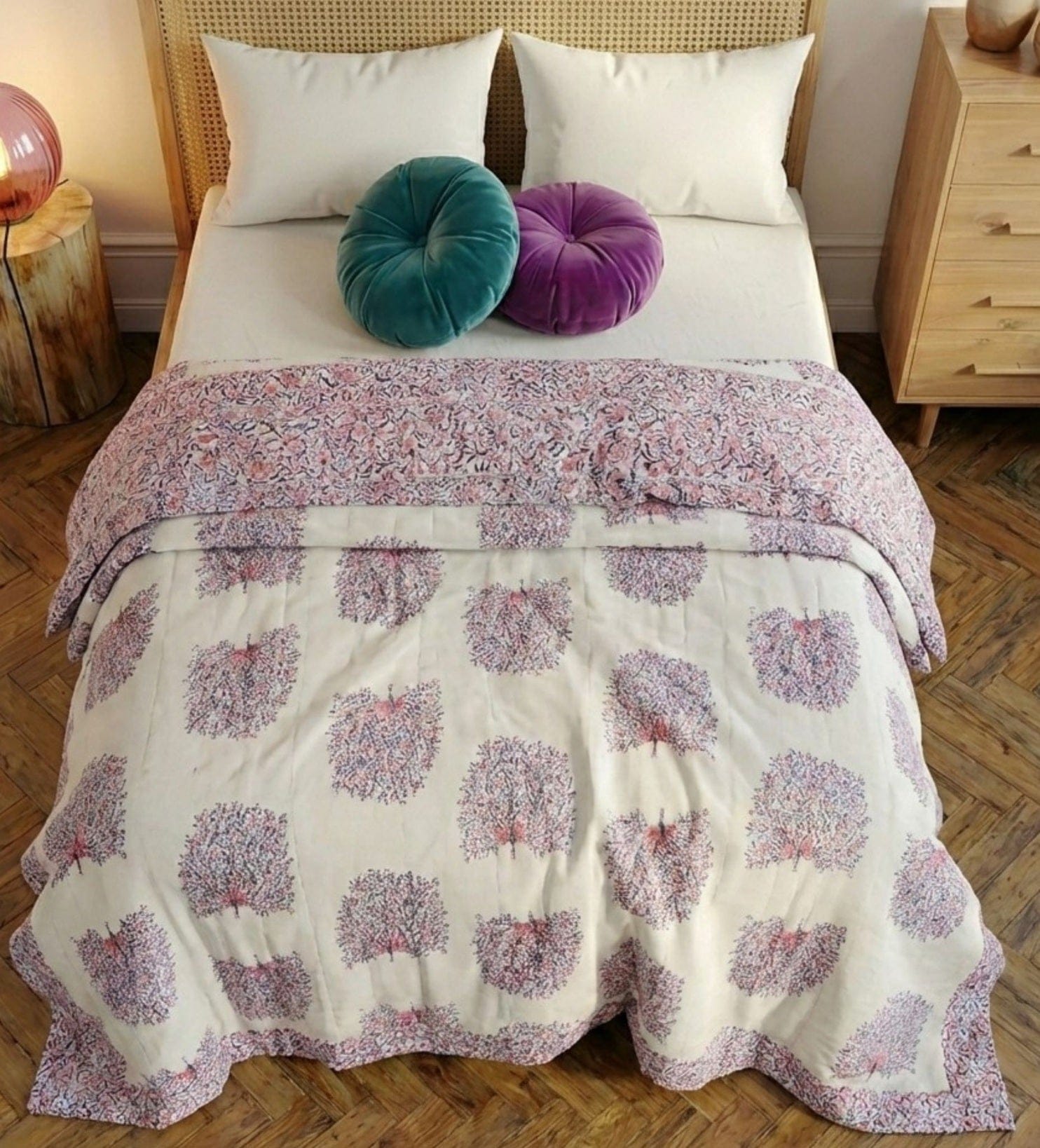 Reversible quilt with peacock feather design by Bombaybirds, featuring soft cotton fabric and intricate hand-stitched details.