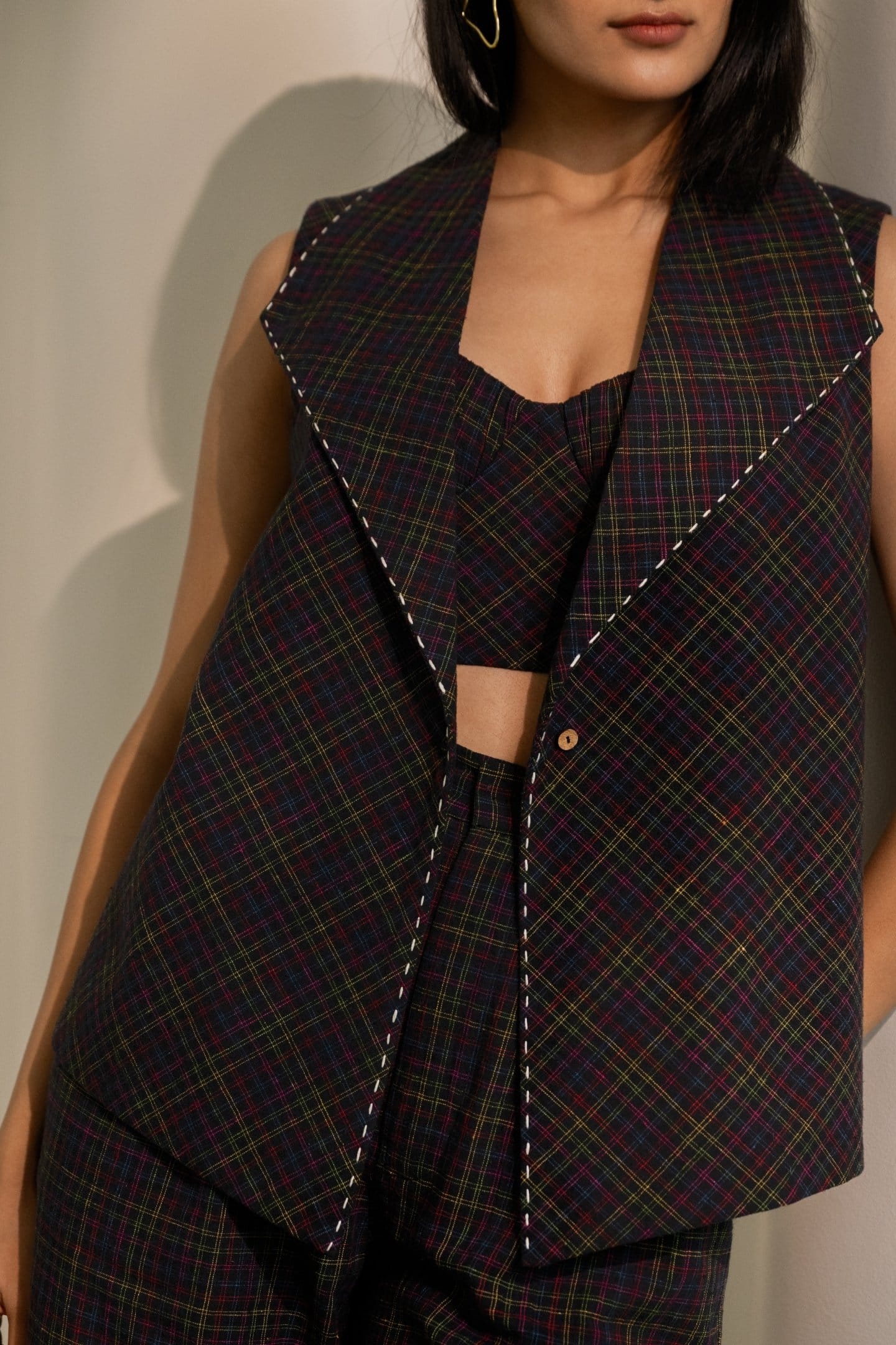 Black Prism blazer top with colorful checkered pattern from Alternative, featuring a tailored fit and stylish lapel collar.