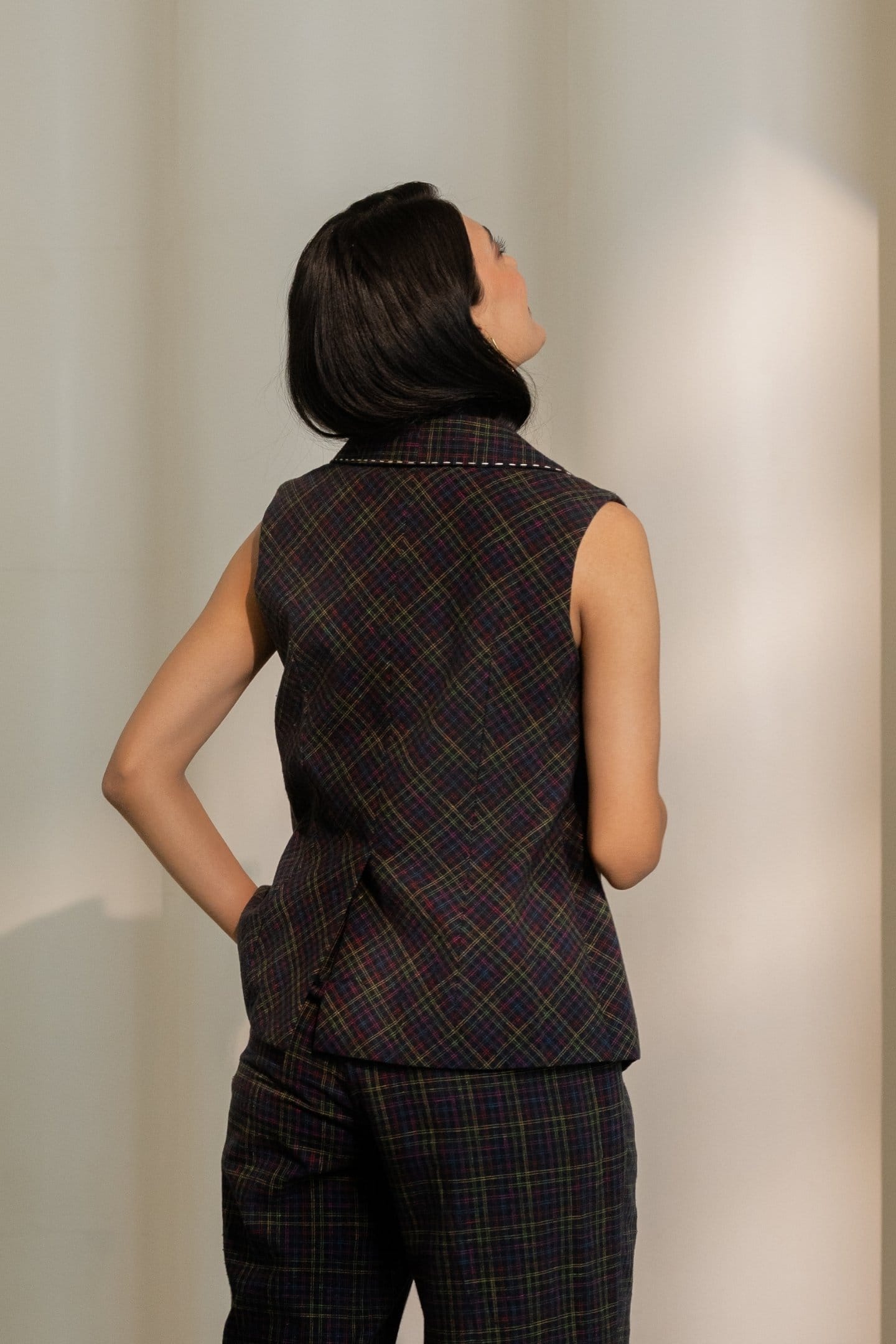 Black blazer top by Alternative with colorful checkered pattern, tailored-fit blazer with lapels and long sleeves.