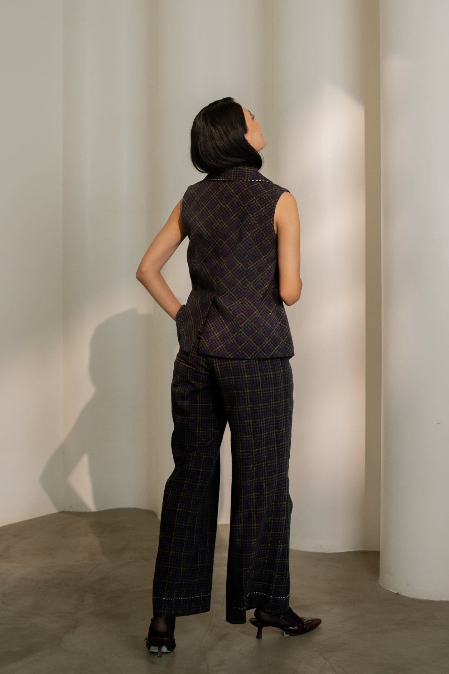Black Prism trousers by Alternative featuring colorful checkered pattern, paired with a matching blazer and top.