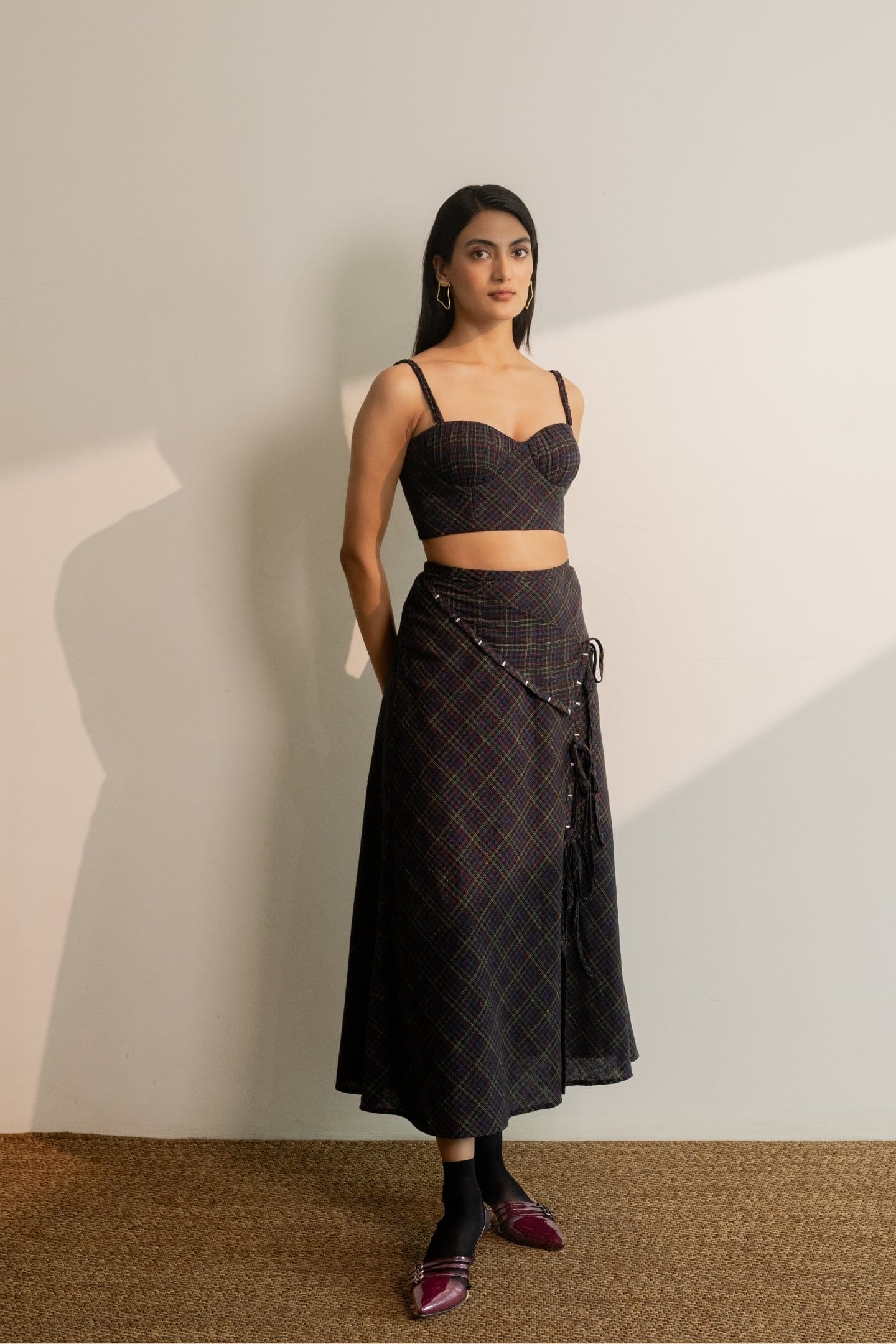 Black Prism tie-up skirt from Alternative with colorful checkered pattern, styled with a matching bralette.