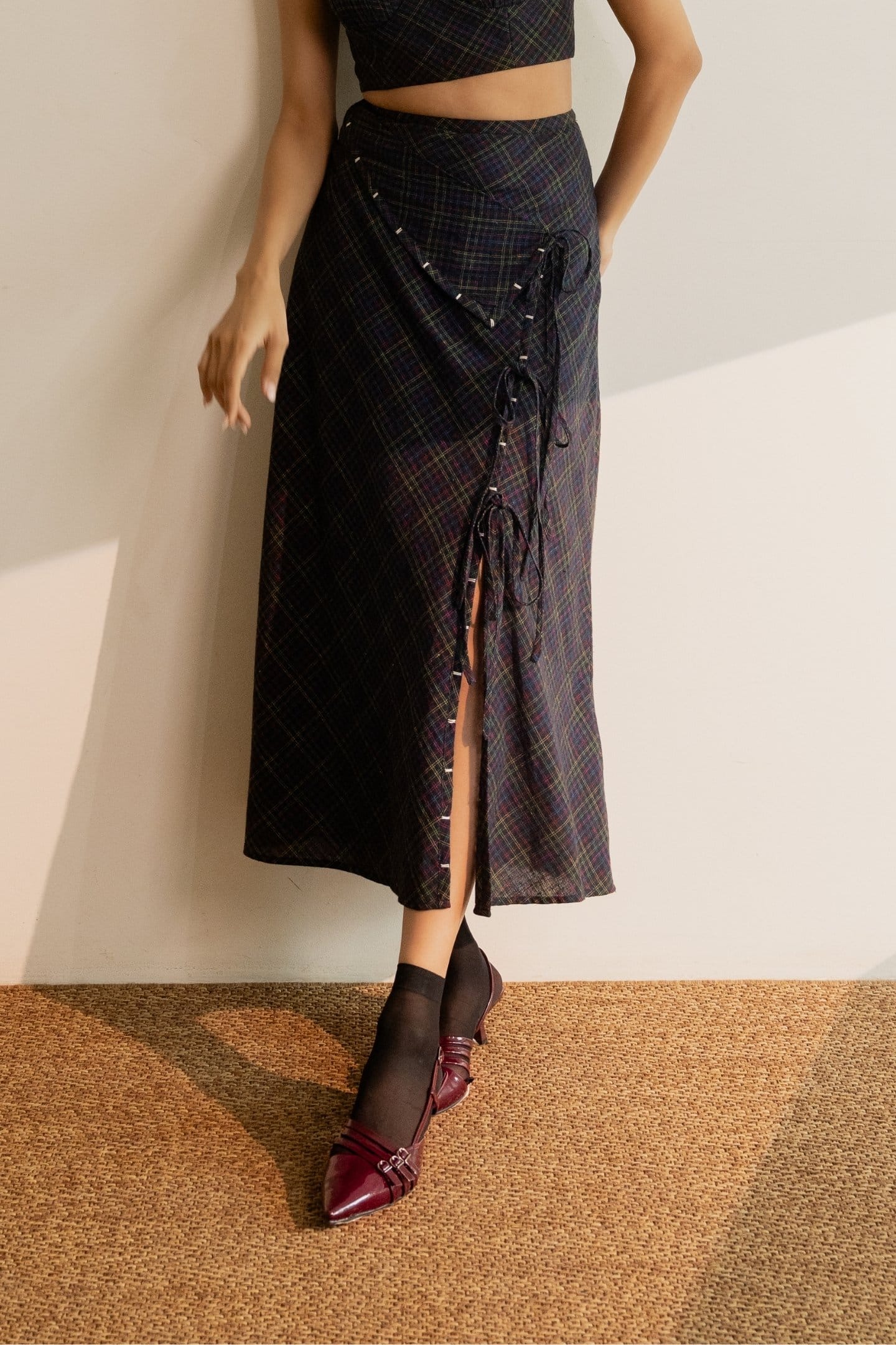 Black Prism tie-up skirt with colorful checkered pattern from Alternative, featuring a stylish wrap design and adjustable ties.