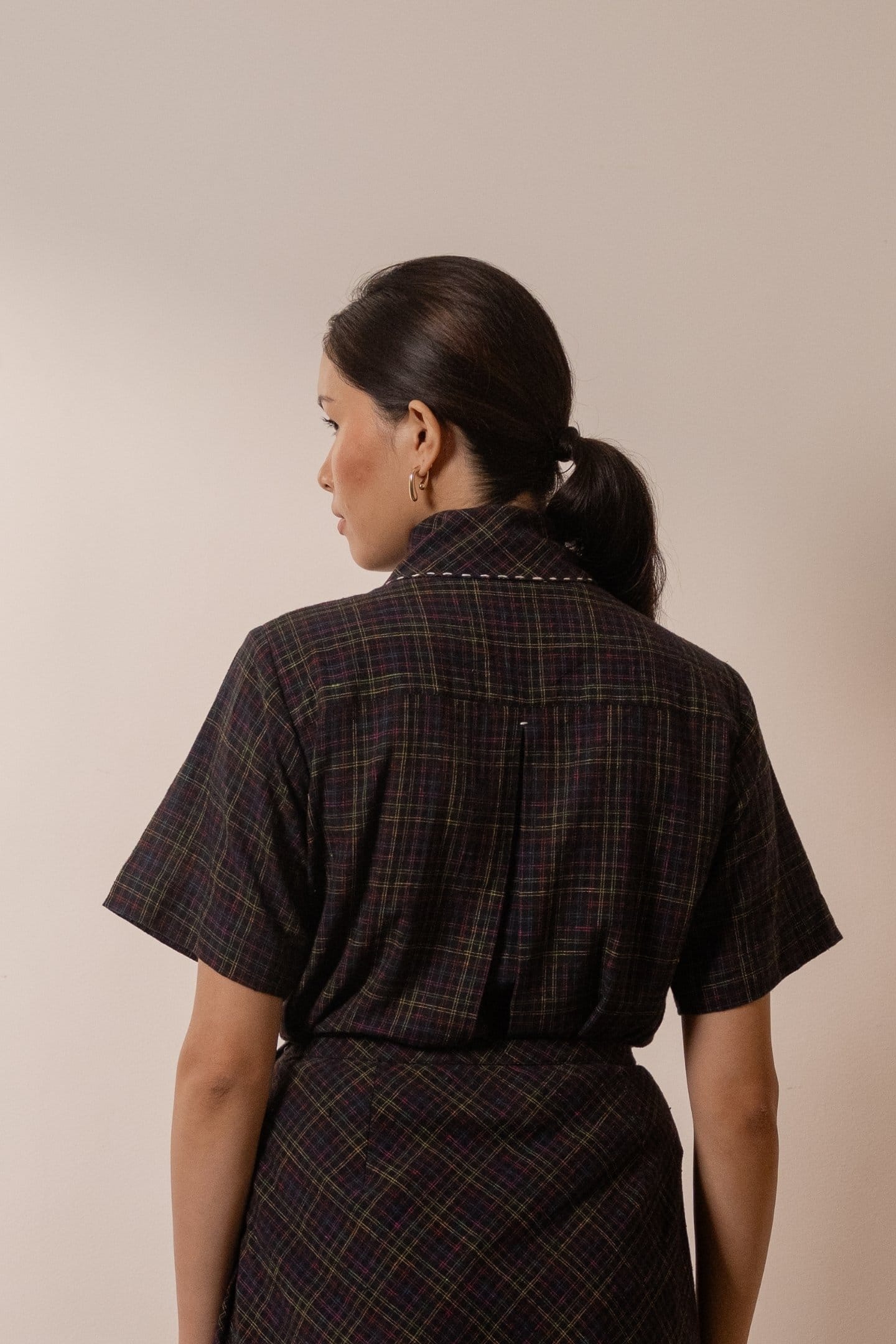 Alternative Prism tie-up top in black with colorful checkered pattern, featuring a stylish design and adjustable straps.