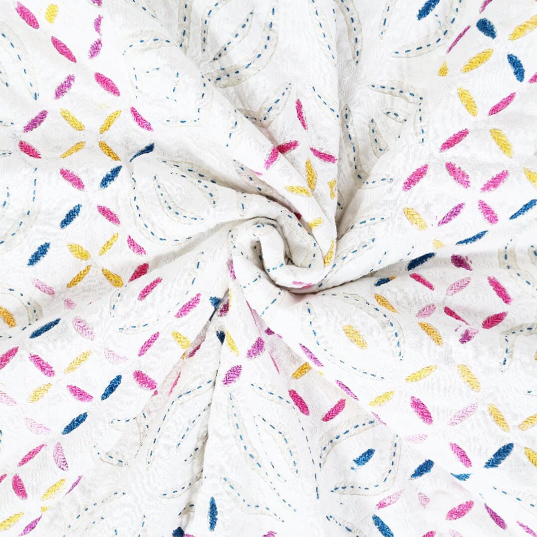 Close-up of Bombaybirds Kutch rainbow quilt showing colorful cotton fabric texture and soft, woven design.