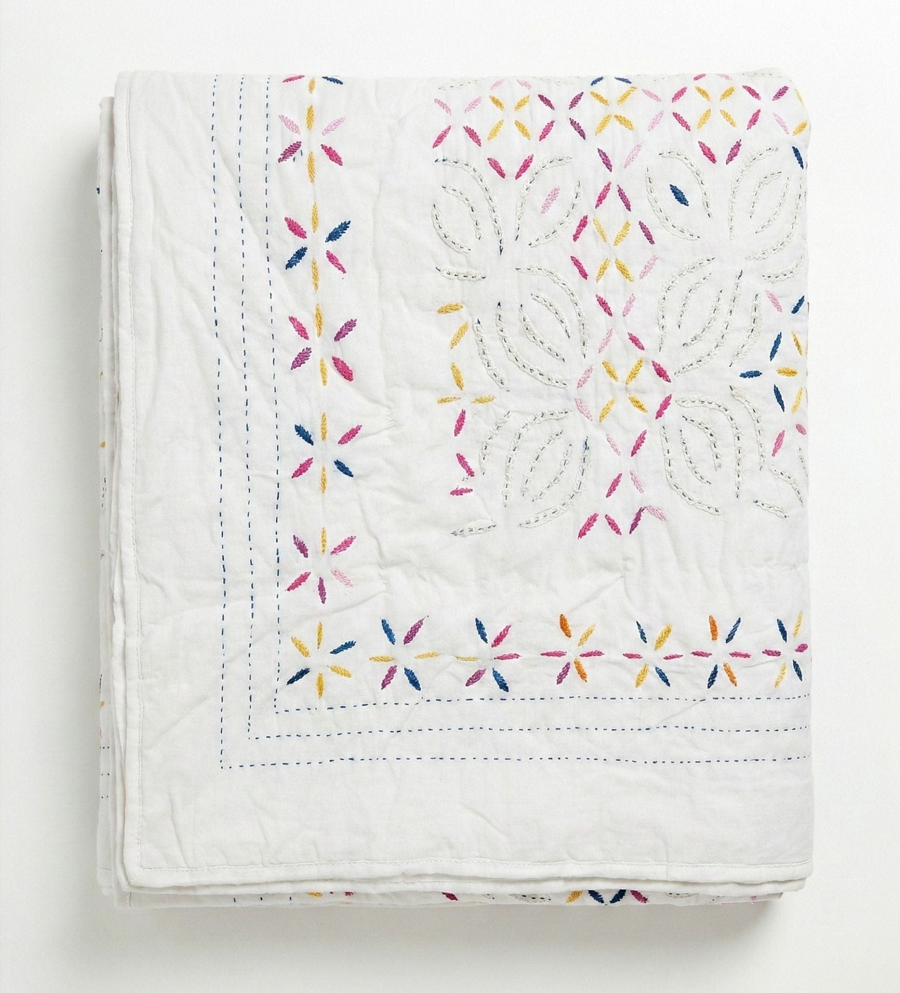 Colorful Kutch rainbow quilt by Bombaybirds, a vibrant living room accessory with a white and multicolor pattern.