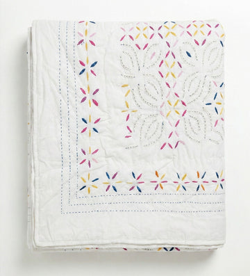 Colorful Kutch rainbow quilt by Bombaybirds, a vibrant living room accessory with a white and multicolor pattern.