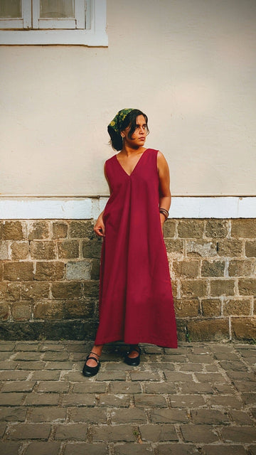 Deeta Ruby dress displayed on a mannequin, featuring a vibrant red fabric with a fitted bodice and flowing skirt.