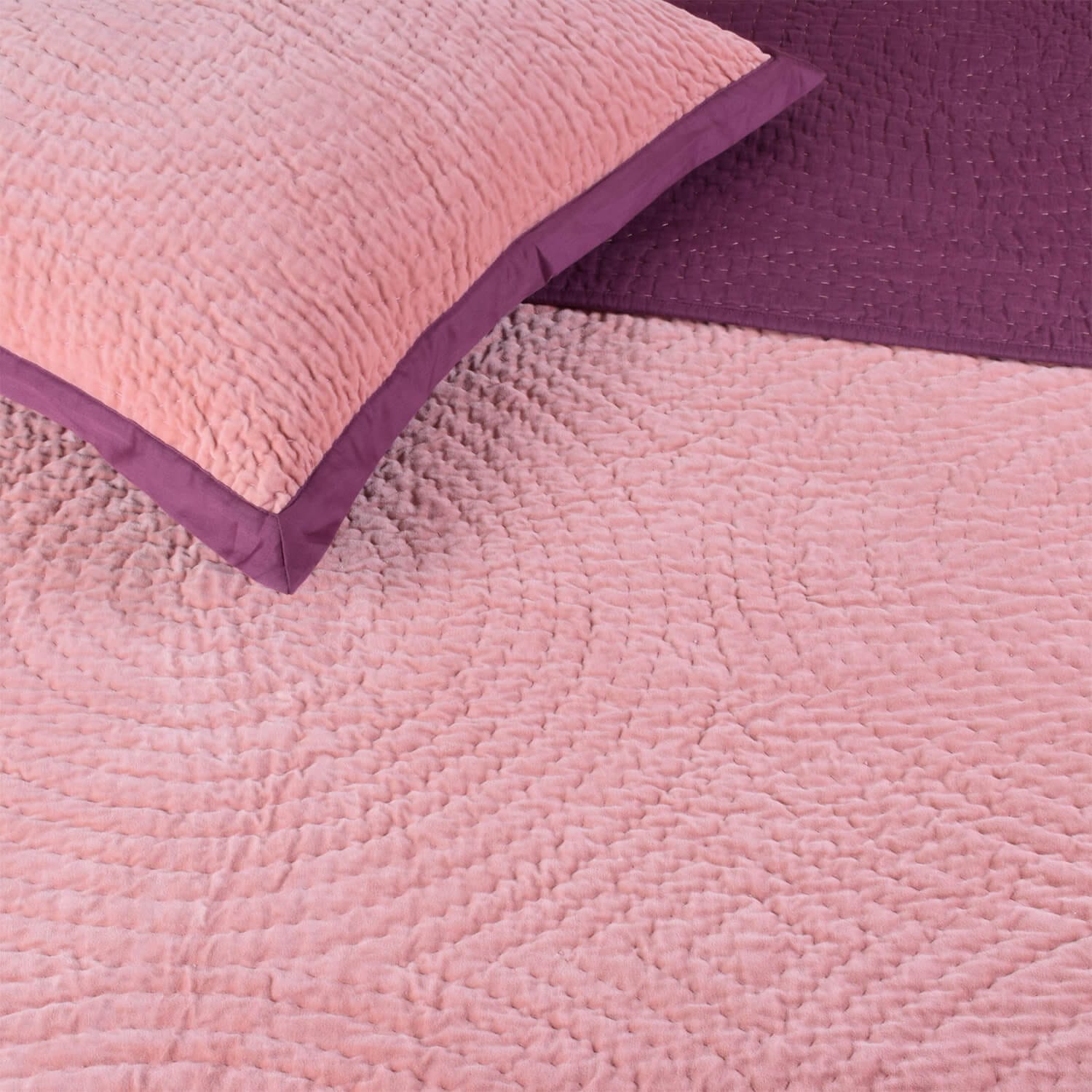 Close-up of Bombaybirds Pink Berry velvet reversible quilt showing pink velvet fabric with detailed round stitching.