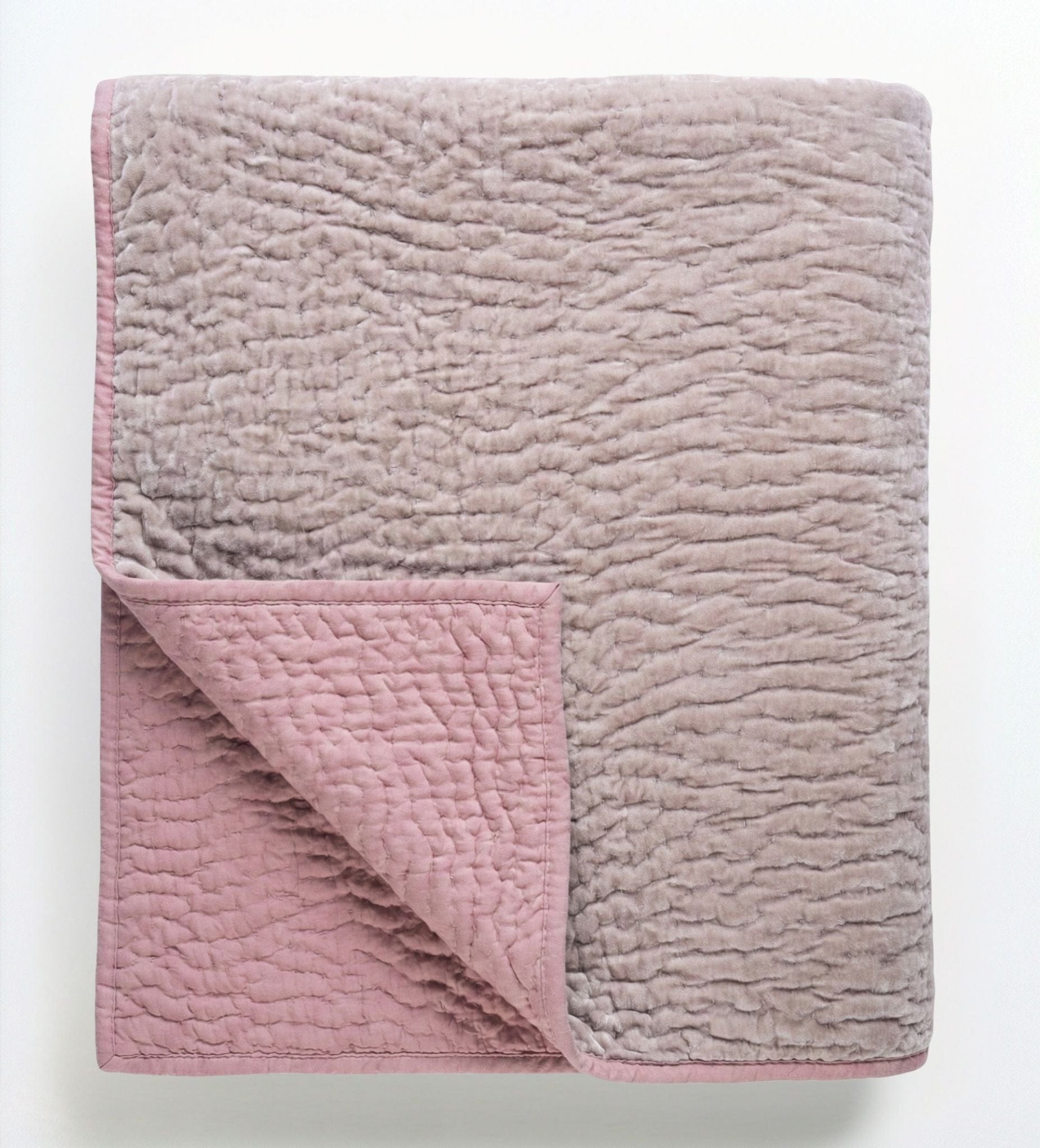 Reversible blush rose and taupe velvet quilt by Bombaybirds, showcasing soft, smooth fabric and elegant design for living spaces.