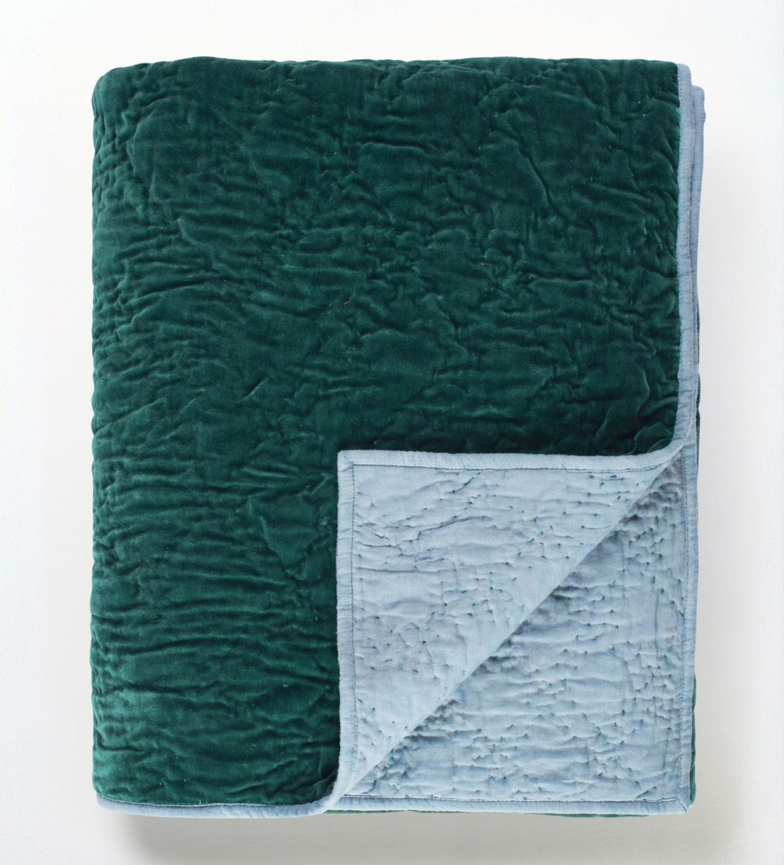 Emerald celeste velvet reversible quilt from Bombaybirds, soft and luxurious living room throw with rich green color and plush texture.