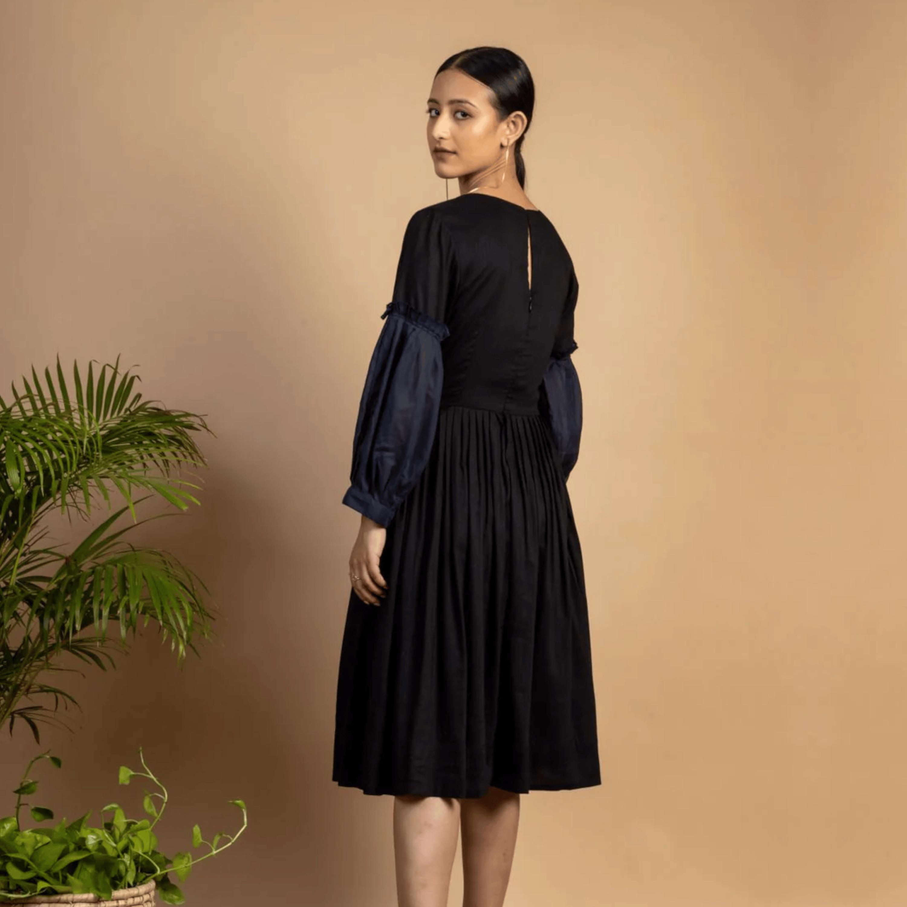 Black Sophia dress by Doodlage, stylish and elegant, with a fitted silhouette and subtle detailing visible in the image.