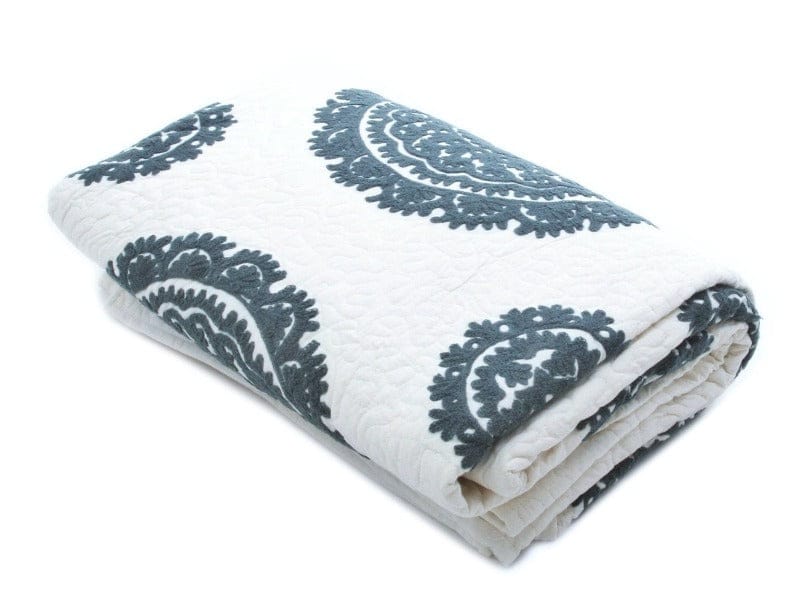 Grey Suzani quilt for living spaces by Bombaybirds, featuring intricate traditional embroidery on soft fabric.