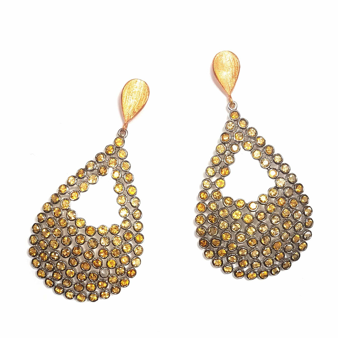Ofelia earrings by Bombaybirds featuring intricate silver-tone floral design and dangling elements on a neutral background.