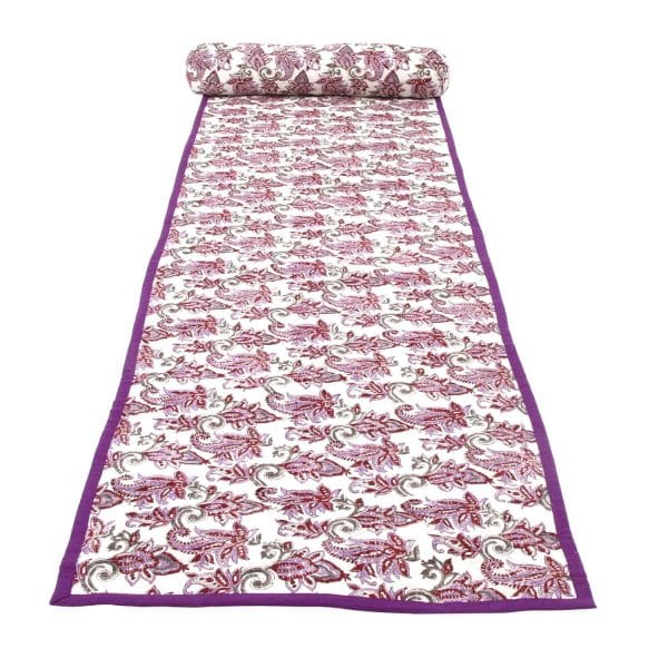 Violet chintz beach mat by Bombaybirds laid out on sand with floral pattern, perfect for relaxing at the beach.