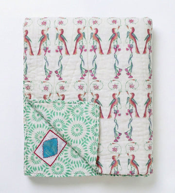 Reversible Ornitho blanket by Bombaybirds featuring green and white geometric patterns for living room decor.